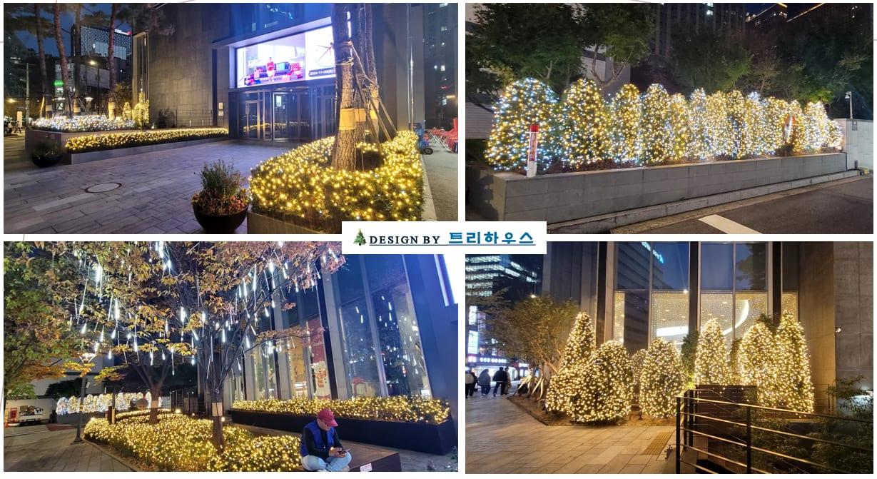 라이나타워 — 건물 앞 화단을 감싼 웜화이트 조명